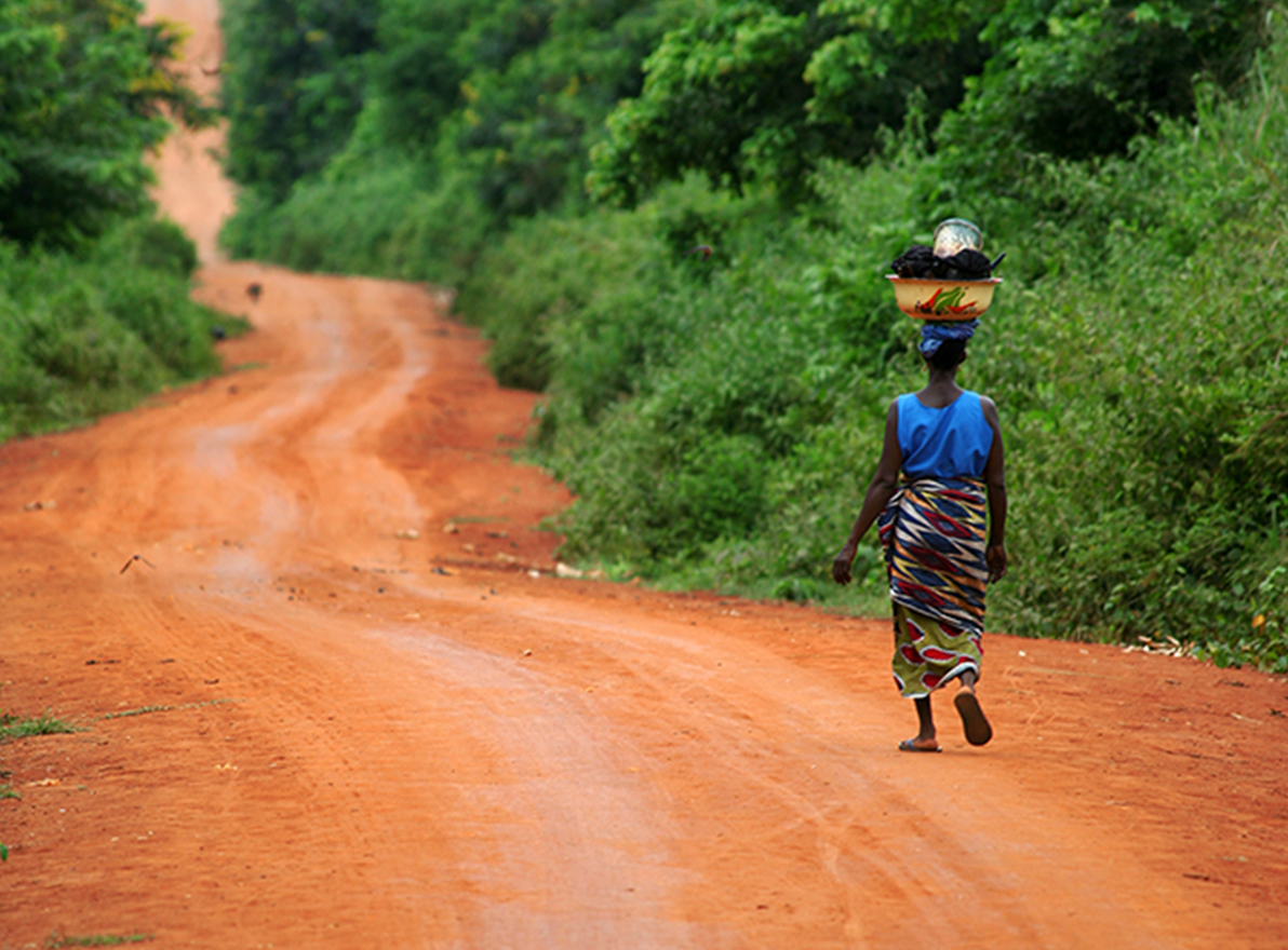 Clinical Trials in Pharmaceutical Development, African woman walking down dirt road
